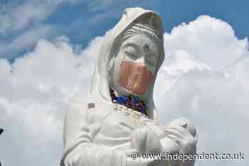 Giant face mask added to Buddhist statue in Japan to pray for the end of Covid
