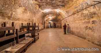 Who dug the sandstone caves along St. Paul's riverfront?