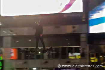 Spectators surprised by man flying through Times Square on a hoverboard