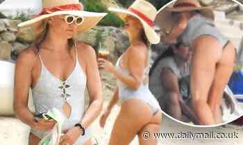 Kate Hudson puts her derriere on display in sexy silver bathing suit as she frolics on the beach