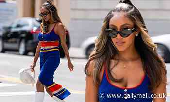Tayshia Adams earns her fashion stripes as she steps out in plunging button down dress
