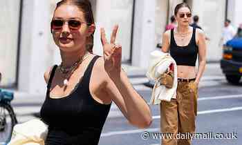 Gigi Hadid shows off her very taut tummy before walking her first fashion show since giving birth