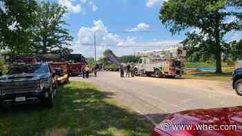 Truck driver rescued after striking power lines causing electricity to tear through road in Henrietta