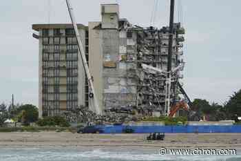 Four more bodies found in condo rubble; at least 16 dead