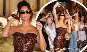 Kim Kardashian puts on a VERY leggy display in PVC leopard print dress