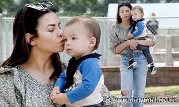 Jenna Dewan plants a sweet kiss on her one-year-old son Callum as they head for a day in the park