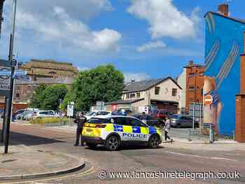 Roads closed in Blackburn as officers deal with woman on roof of carpark