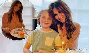 Cheryl poses for a snap with Kimberley Walsh's son Bobby while celebrating her 38th birthday