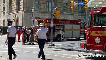 Crane falls onto building in downtown Toronto, causing damage but no injuries, police say