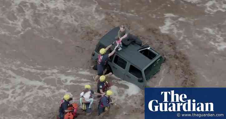 Arizona: stranded family rescued as flash floods inundate cities – video report