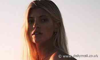 Devon Windsor shows off her baby bump as she poses naked by the ocean