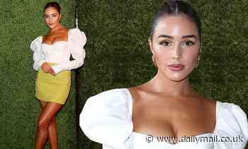 Olivia Culpo puts on a leggy display in a green miniskirt at a Sports Illustrated Swimsuit party