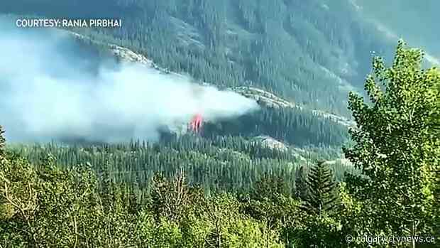 Water bombers attack brush fire burning east of Canmore