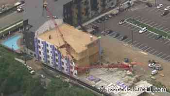 Crane collapse damages building under construction, knocks out power