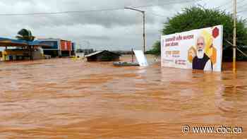 Rescue teams in India struggle to reach submerged homes following flooding, landslides
