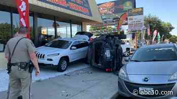 One killed after car crashes into auto dealership in Clovis