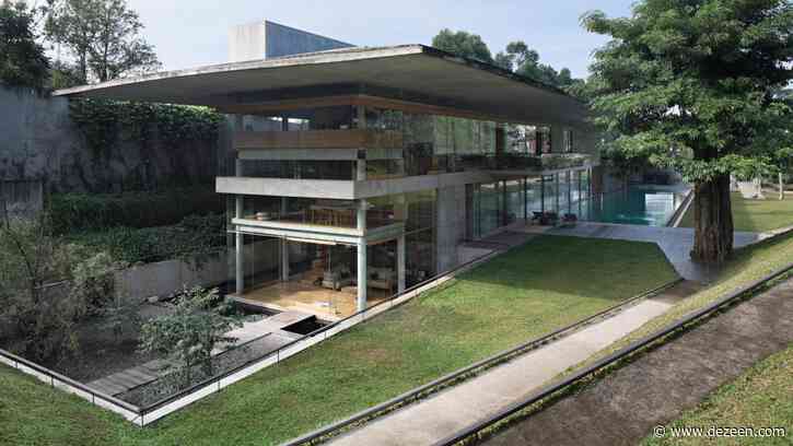 Giant concrete roof shelters home in Indonesia by Andramatin