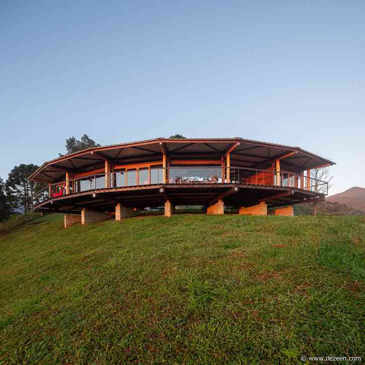 Gui Paoliello Arquiteto completes curved wooden house in Brazil's Morro Cavado valley