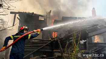 Wildfires rip through Greek forests, cut large island in half