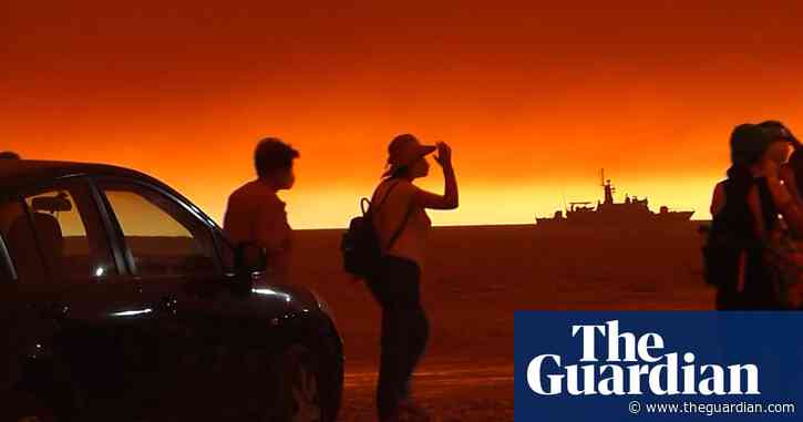 Thousands flee Greek island as wildfires raze forest and homes