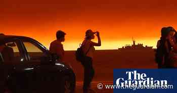 Thousands flee Greek island as wildfires raze forest and homes - The Guardian