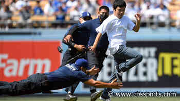 LOOK: Dodgers ball girl takes down fan who ran onto field during game