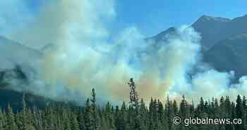Crews continue battling grass fire near Canmore, traffic moving east and westbound again