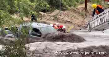 Video Shows Dramatic Moment Rescuers Save Woman Trapped Inside Truck as Floodwaters Rage Around Them