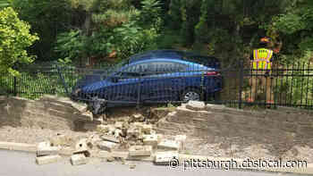 Car Crashes Over Hillside And Through Fence, Into Wall  In Brentwood