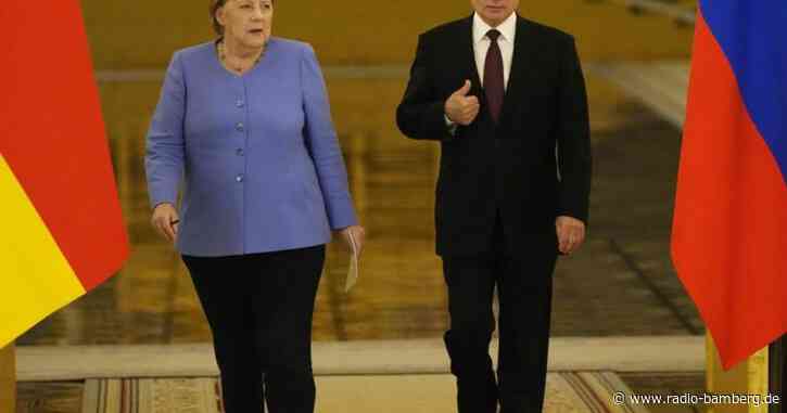 Treffen im Kreml: Viele Probleme und Blumen für Merkel