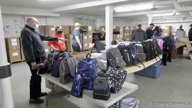 Team of three fills 3,000 backpacks full of supplies for children in need
