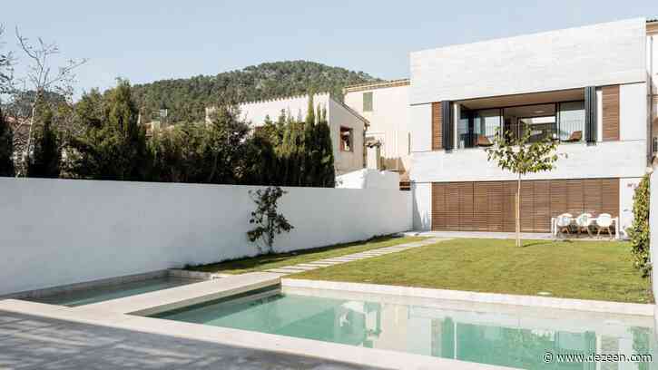 Large wooden shutters filter light and air into Mallorcan home by Company Studio