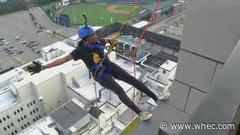 Deanna Dewberry rappels down Kodak Tower to support Boy Scouts