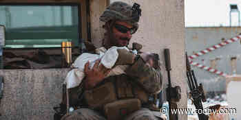 The story behind the viral photo of a Marine holding a baby at Kabul airport