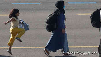 Afghan girl seen in viral photo skipping on airport tarmac after arriving in Brussels following evacuation