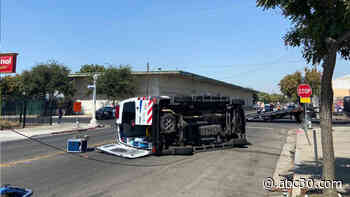 Ambulance rolls on its side in downtown Fresno after collision with SUV