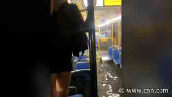 Floodwaters force bus riders to stand on seats