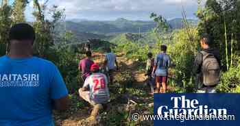 Fijian doctors trek up and down mountains to reach remote village with Covid vaccines – video