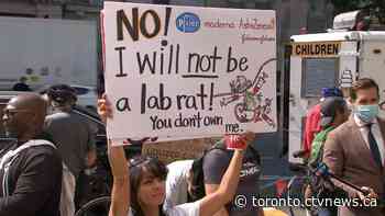 Anti-vaccine protesters gather outside Toronto General Hospital as part of nationwide action
