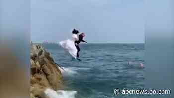 WATCH:  Bride and groom jump into the sea in full wedding attire