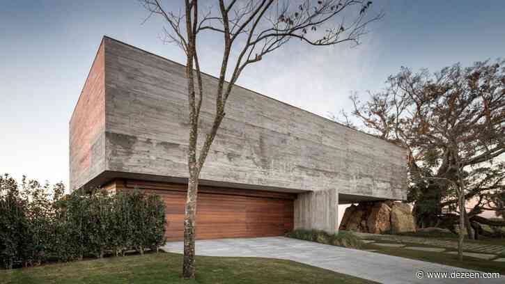 Fig House by Stemmer Rodrigues appears supported by a natural rock formation
