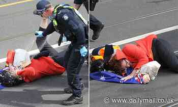 Policemen douse an elderly woman with pepper spray during Melbourne's anti-lockdown protests