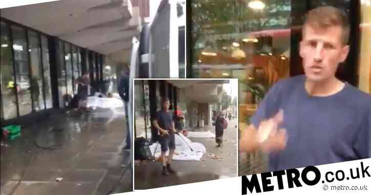 Street cleaner filmed spraying jet washer at homeless person in makeshift bed