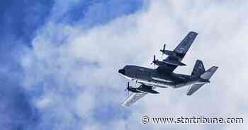 Why do military cargo planes regularly fly in pairs over the Twin Cities?