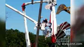Pilot left dangling in power lines after crash