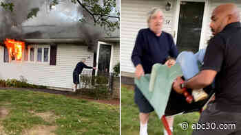Bystanders carry 97-year-old woman out of burning home on chair: video