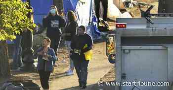 Minneapolis city workers clear homeless encampment in the median of Franklin Avenue