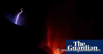 Lightning flashes over La Palma volcano as lava engulfs buildings – video