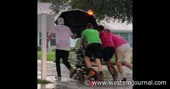 Elderly Woman Stuck in Downpour with Groceries Until Four Men Arrive to Help