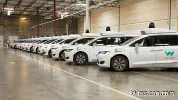 Waymo's self-driving taxi struggles with left turns and puddles. But it's still winning over some Arizona riders